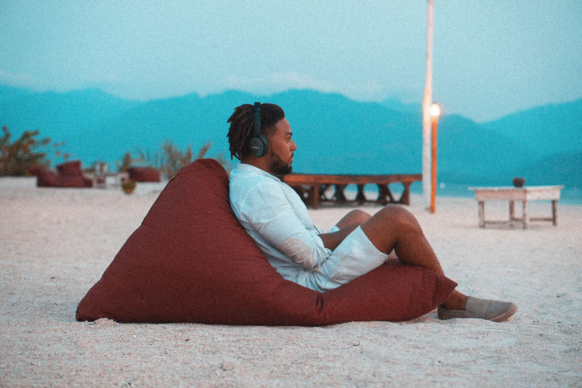 Corey reading on a beach lounger at dusk